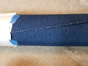 lot 3233 image: Calico Corners. Upholstery weight blue denim fabric. 54 x 11 yards
