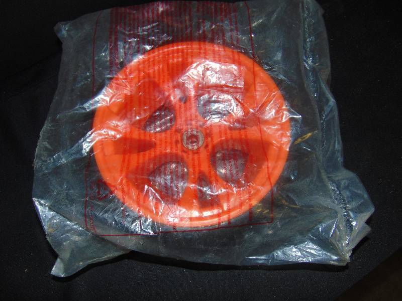 lot 9035 image: Orange and Black Plastic Wheel 10 diameter, 12 center hole w bearing