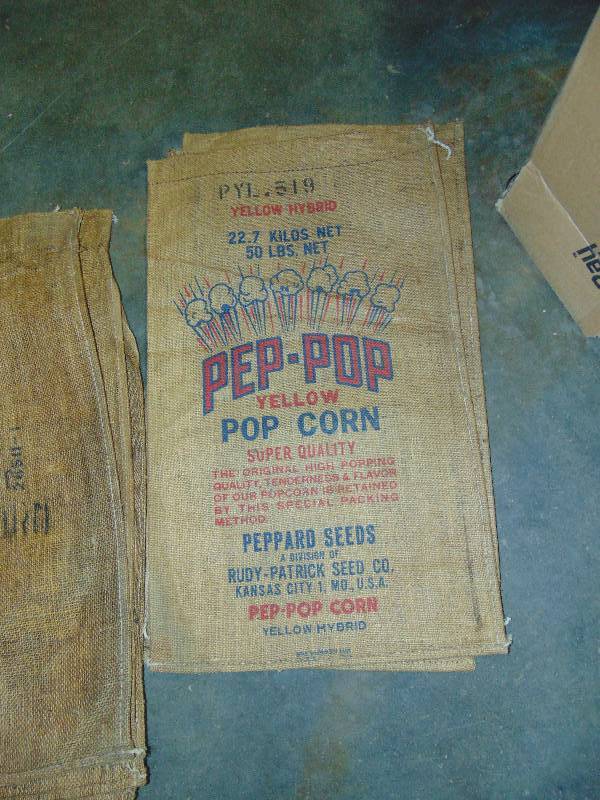 lot 9059 image: (8) ct. lot 50 lb Burlap Popcorn Sacks, 30 x 17 (5) white popcorn, (3) Pep Pop Yellow Popcorn