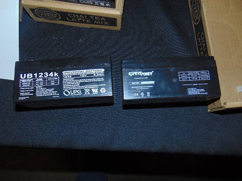 lot 9092 image: (2) ct. lot believed new working batteries (1) UB1234K 12 volt, (1) Expert Power 1233 12 volt