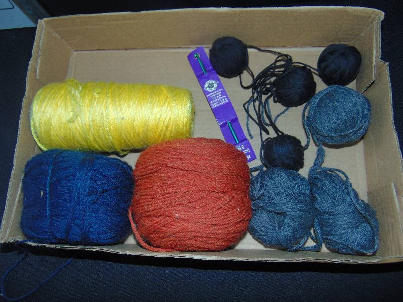 lot 9160 image: Crochet yarn, red, yellow, navy and gray w 4.5 mm hook