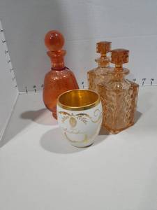 lot 1155 image: Empty perfume bottles and a gold cup