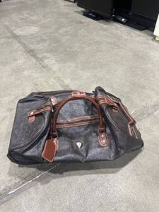 lot 1595 image: Calpak tooled leather rolling luggage