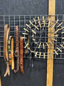 lot 1841 image: Tooled leather and other belts (6) with 2 tier clothes hanging ring