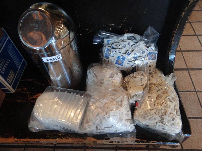 lot 138 image: Counter-top Trash can, SaltPepper & Creamer packets, plastic condiment containers.
