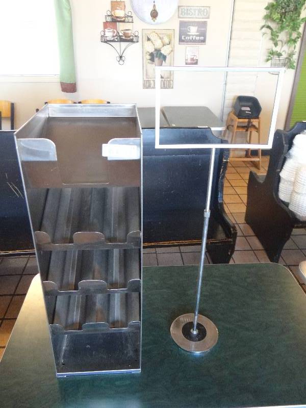 lot 139 image: Stainless Steel Lid Dispenser, Adjustable Sign Stand, & 2 Stainless Steel Drip Trays.