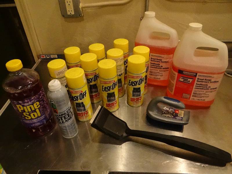 lot 238 image: Large Lot of Cleaning Supplies - Easy Off, CLR, Sanitizer wpumps, Pine-Sol, Grill Brush, Scrub Brush.