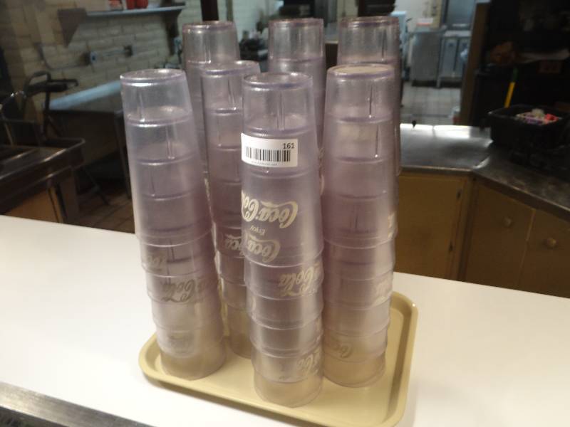 lot 161 image: Tray of 45 G.E.T. Brand 24 oz. Clear Plastic Coca Cola Glasses.