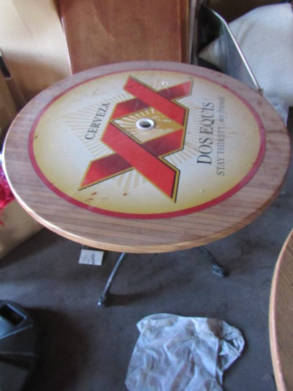 lot 1865 image: 35 Round Branded Dos Equis Out Door Table