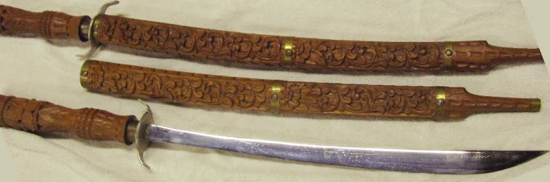 lot 6177 image: Two SWORDS with beautifully carved wooden Sheaths VERY COLLECTIBLE