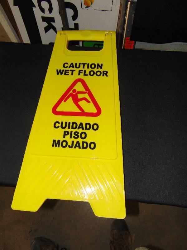 lot 1100 image: Caution Wet Floor Sign, English and Spanish