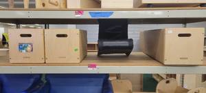 lot 13911 image: Contents of Shelf - Kaplan Wooden Organizers and a Black Rocker Chair