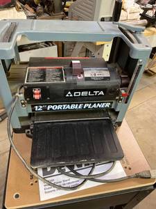 lot 1001 image: Delta portable planer on a DeWalt stand