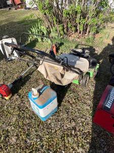 lot 2037 image: Lawn Boy push mower with utility jug