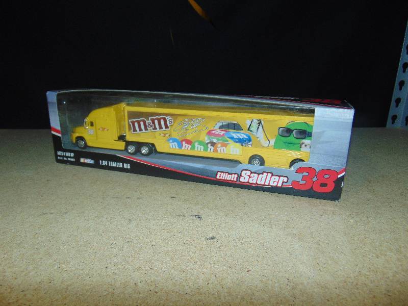 lot 4021 image: Elliott Sadler #38 M&Ms Racing 164 Scale transporter and die-cast car, Winners Circle