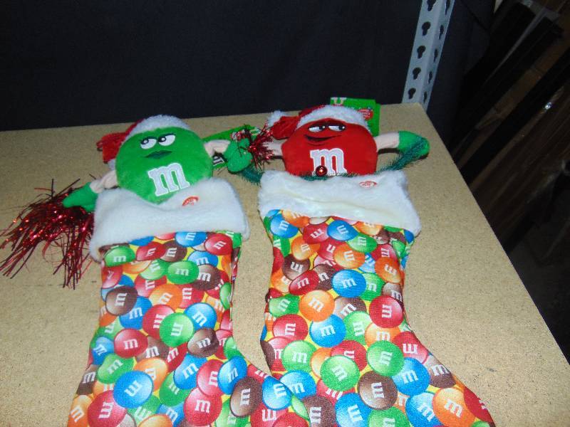 lot 4038 image: Red & Green M&M Stockings, sing I want Candy, will need batteries- not included.