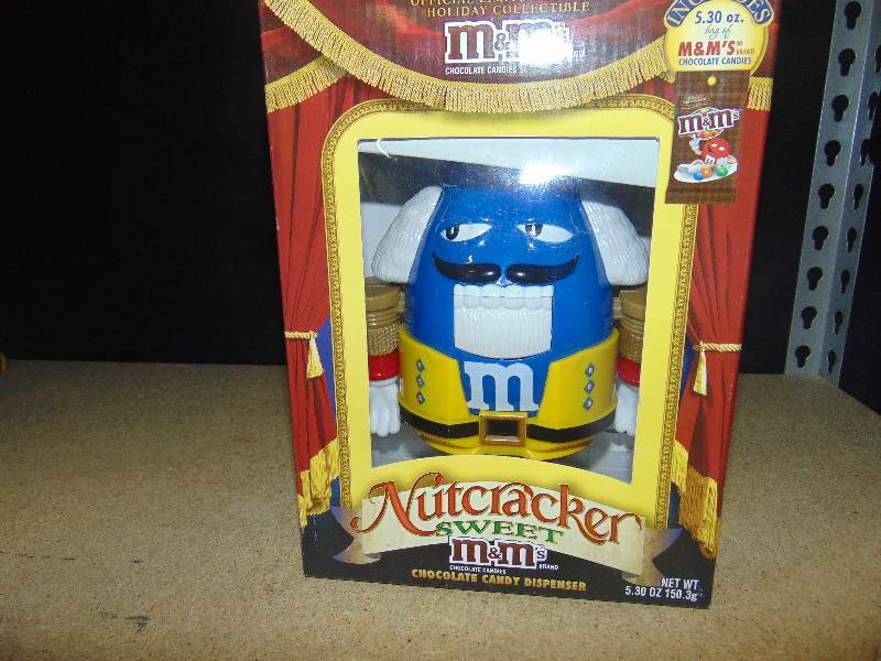 lot 4076 image: The Nutcracker Suite M&Ms Dispenser, blue with yellow coat, in original box