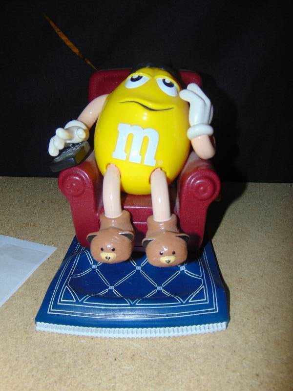 lot 4104 image: M&Ms Yellow in recliner candy dispenser, 9 tall
