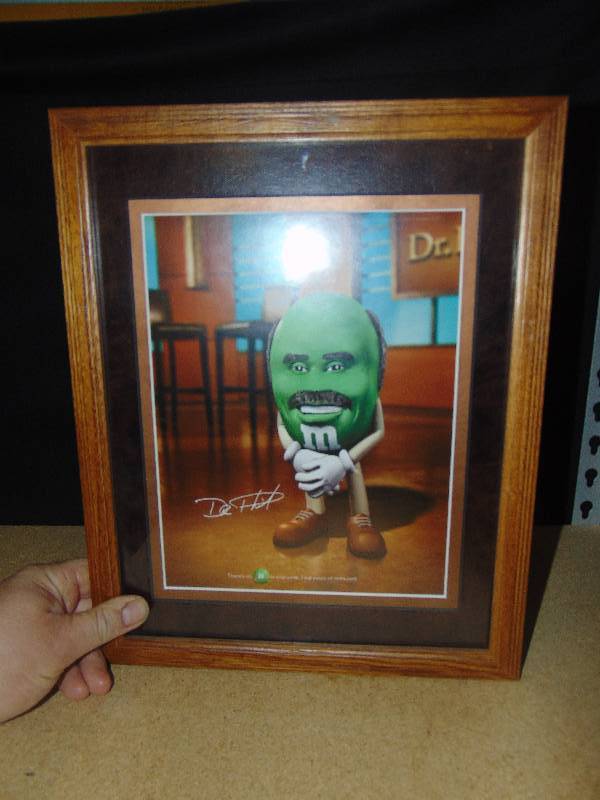 lot 4130 image: M&Ms Dr Phil advertising picture, professionally matted and framed, 12 x 15