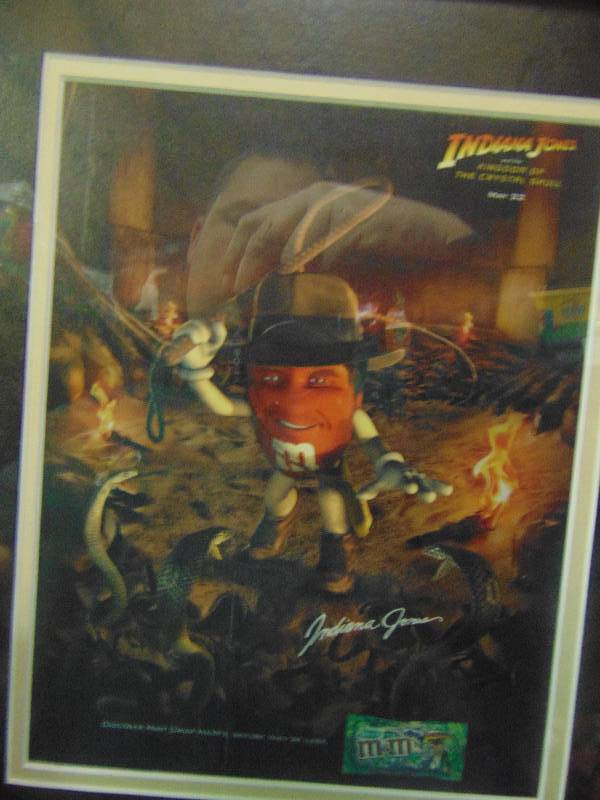 lot 4133 image: M&Ms Indiana Jones advertising picture, professionally matted and framed, 12 x 15