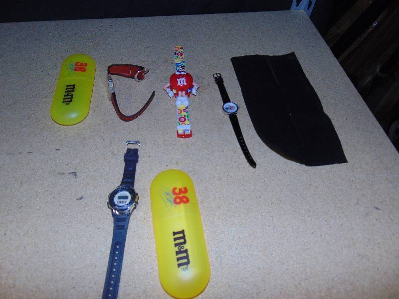 lot 4145 image: (4) ct. lot M&Ms watches (1) Time Machine, (1) #38 racing, (1) Las Vegas 10 Anniversary Elvis, (1) Red M&M Watch