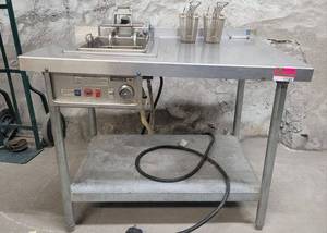 lot 12585 image: Wells F-586 Auto Fry Automatic Frying Machine on a 42in Stainless Steel Prep Table