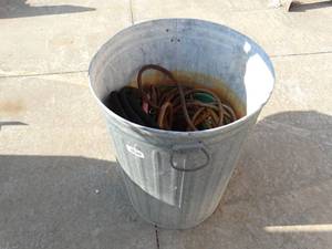 lot 23566 image: Trash can w hoses & misc.