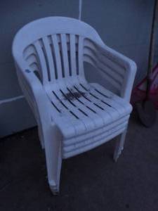 lot 23686 image: Stack of 4 Plastic Lawn Chairs.