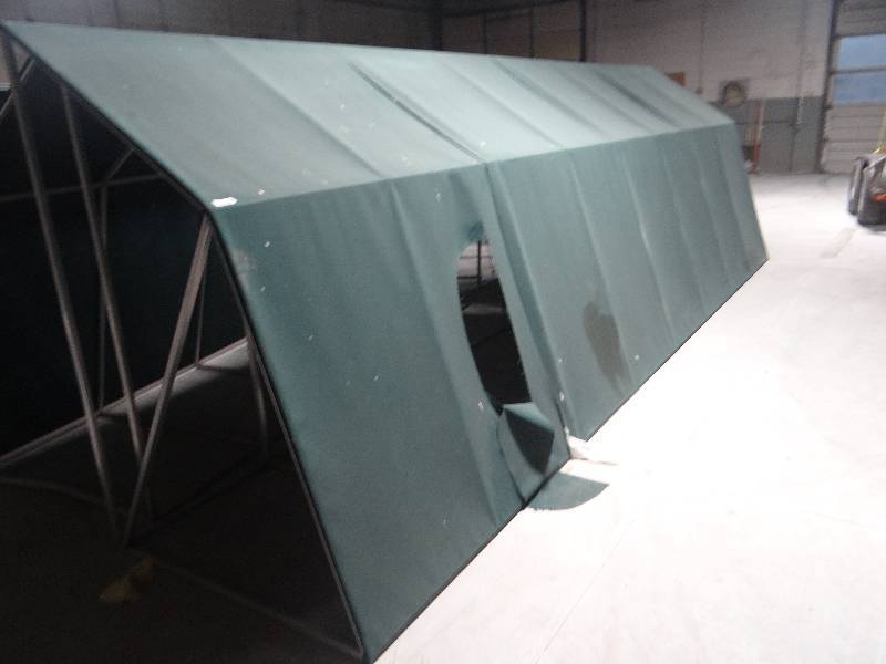 lot 168 image: Large aluminum frame canopyawning. green fabric cover.  6ft tall 4 ft deep 20ft long.