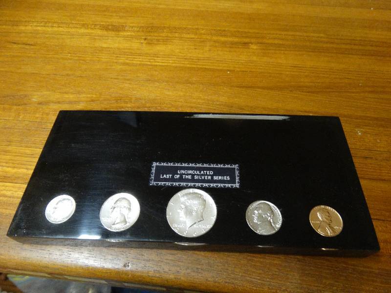 lot 533 image: Uncirculated last of the silver series silver coins in lucite.
