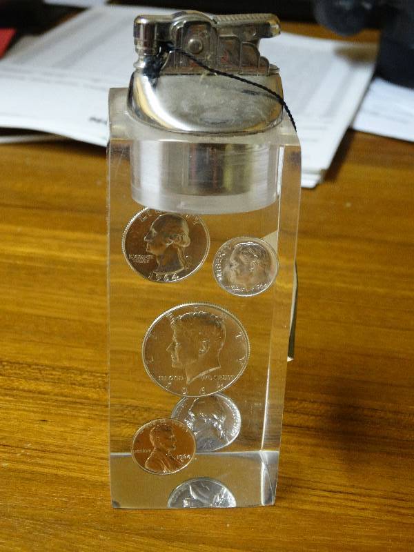 lot 538 image: Table lighter w1964 silver coins in lucite.