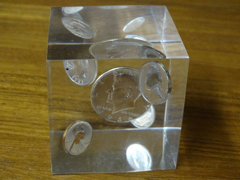 lot 542 image: Silver coin in lucite cube.