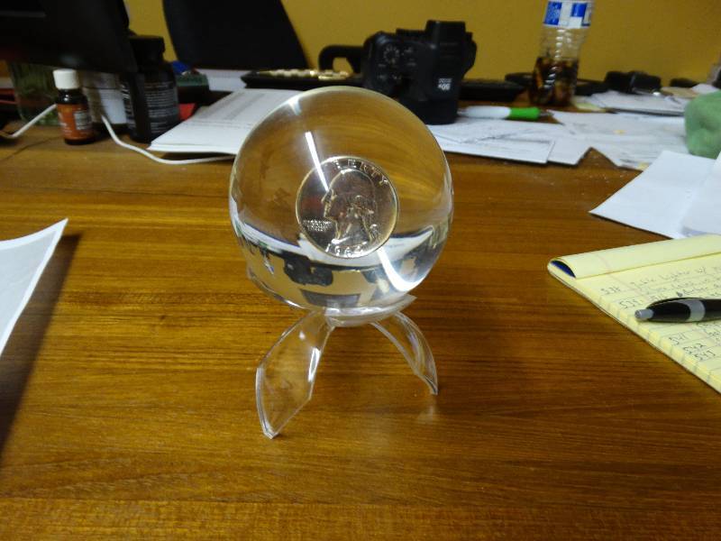 lot 546 image: 1964 Silver quarter in lucite sphere -  stand not included.