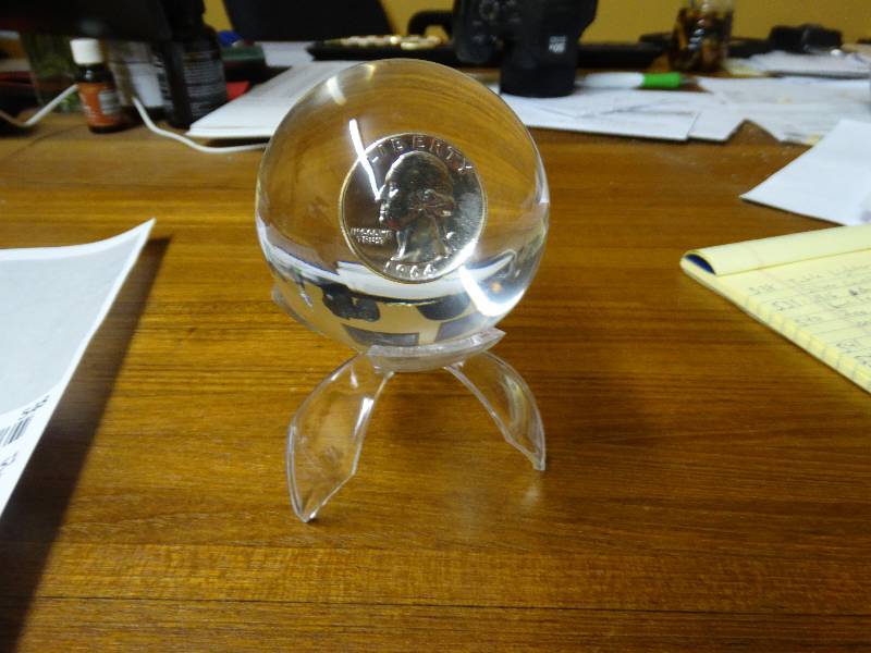 lot 547 image: 1964 Silver quarter in lucite sphere -  stand not included.