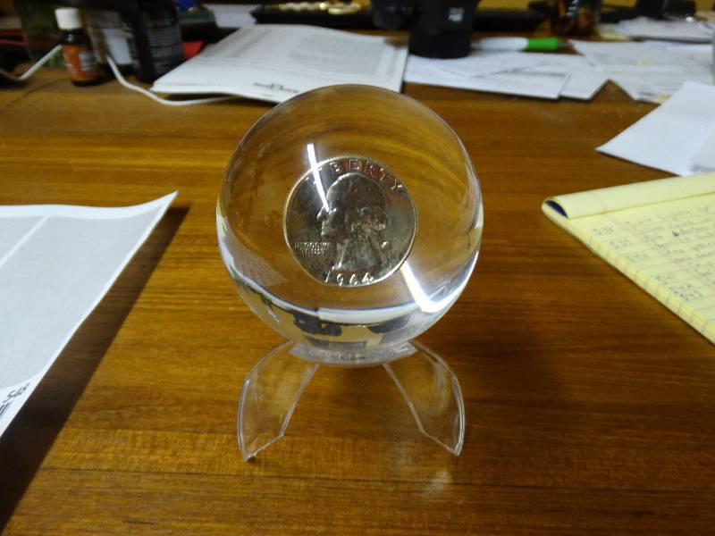 lot 548 image: 1964 Silver quarter in lucite sphere -  stand not included.