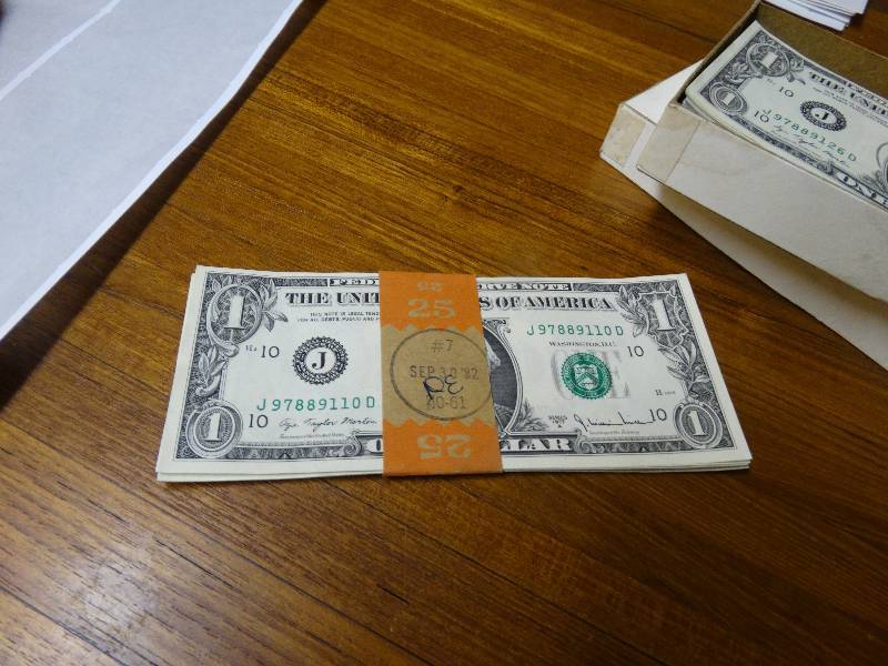 lot 555 image: 16 dollar bills - 1977 A serial number all in order from 110D to 125D uncirculated.