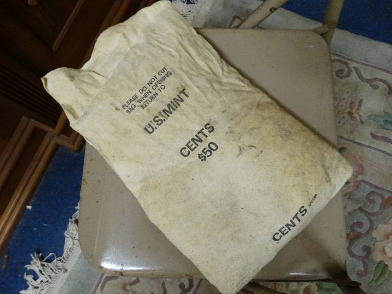 lot 562 image: $50 bag of pennies unopened from the mint no date.