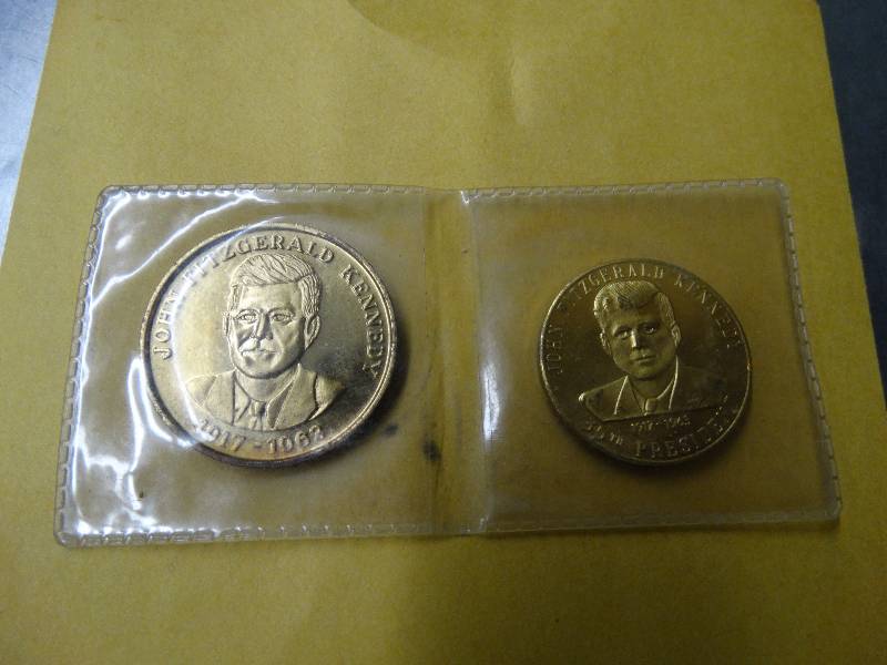 lot 578 image: 2 JFK coins in plastic.