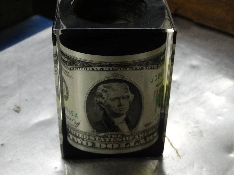 lot 589 image: 2 Dollar bill in lucite.
