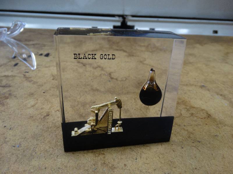 lot 642 image: Lucite black gold wreel oil.