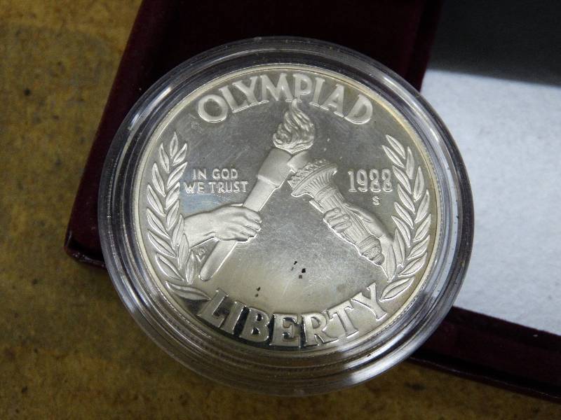 lot 672 image: 1988 Olympiad liberty silver dollar in case.