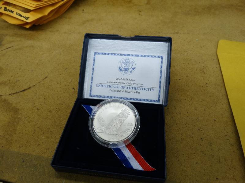 lot 683 image: 2008 Bold eagle commemorative coin in plastic - silver dollar.