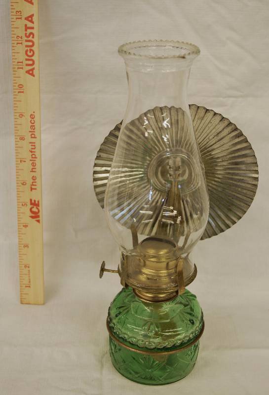 lot 8049 image: Vintage Hurricane Oil Lamp - Green glass with glass globe and metal reflector