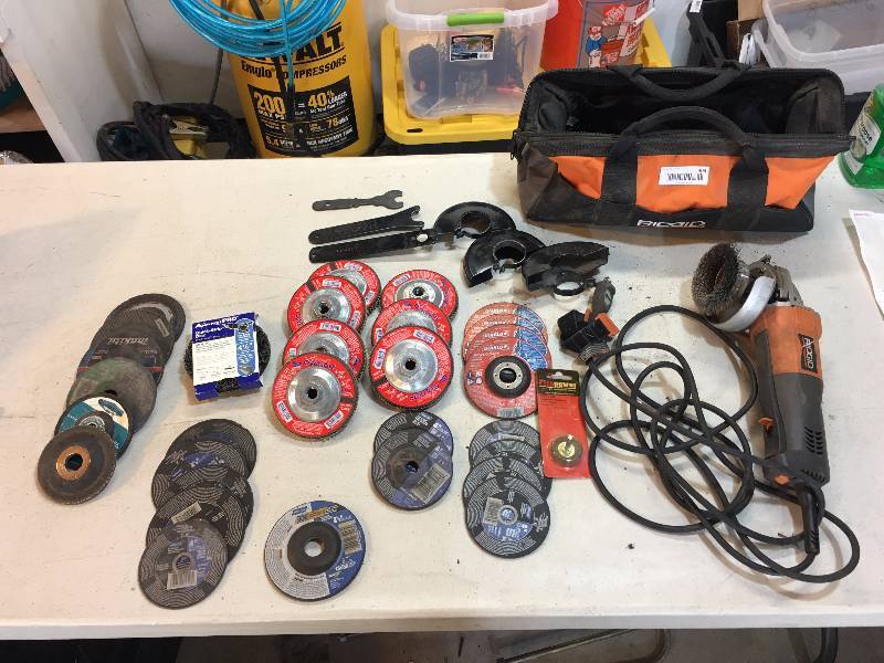lot 403 image: RIDGID ANGLE GRINDER WITH BAG FULL OF CUTOFF DISCS SANDING DISCS AND TONS MORE