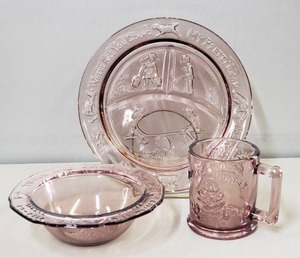 lot 49 image: Mother Goose Child��s Set by Tiara Glassware. Plate, cup, bowl. Amethyst