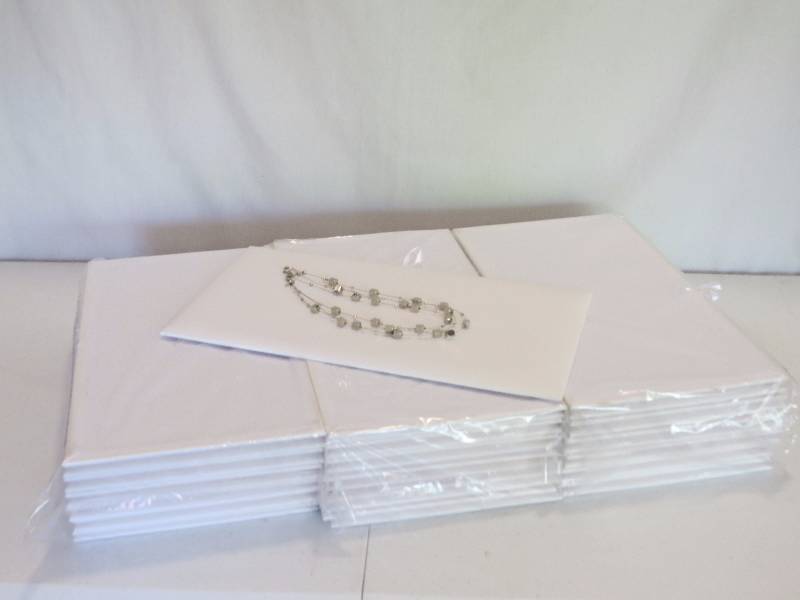 lot 164 image: Lot of 37 White Leatherette Full Size Jewelry Pads (jewelry not included)