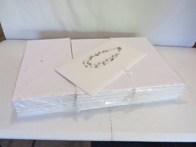 lot 165 image: Lot of 37 White Leatherette Full Size Jewelry Pads (jewelry not included)