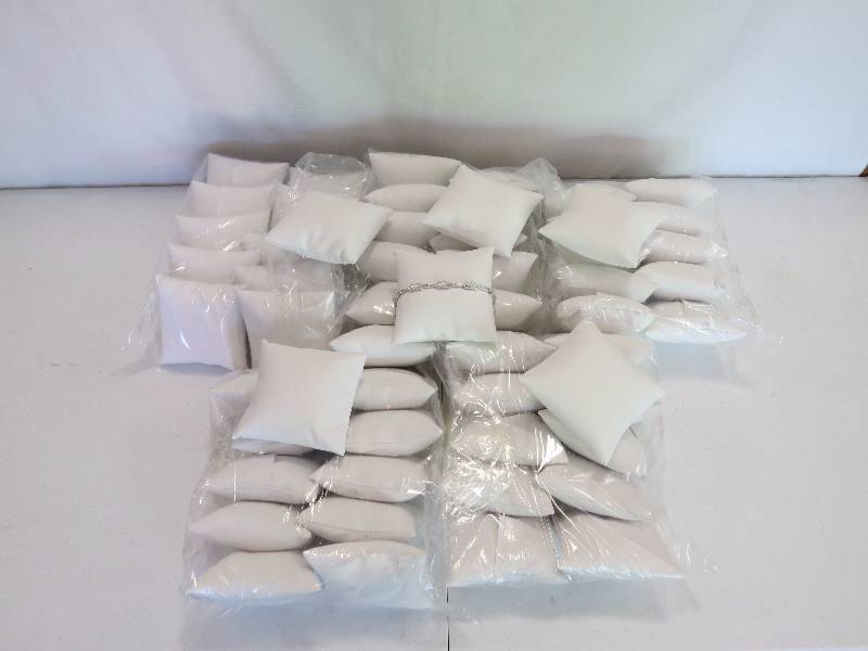 lot 174 image: Lot of 56 4 White Leatherette Ankley Display Pillows (jewelry not included)