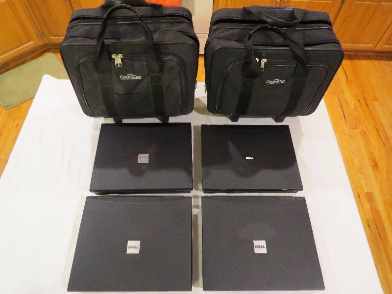 lot 325 image: Lot of 4 Dell Laptops with 2 Laptop Bags on Wheels