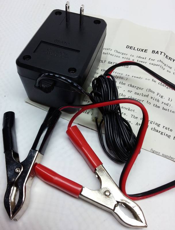 lot 9139 image: Deluxe 12 volt car truck motorcycle battery over night style low amp charger new in the box.
